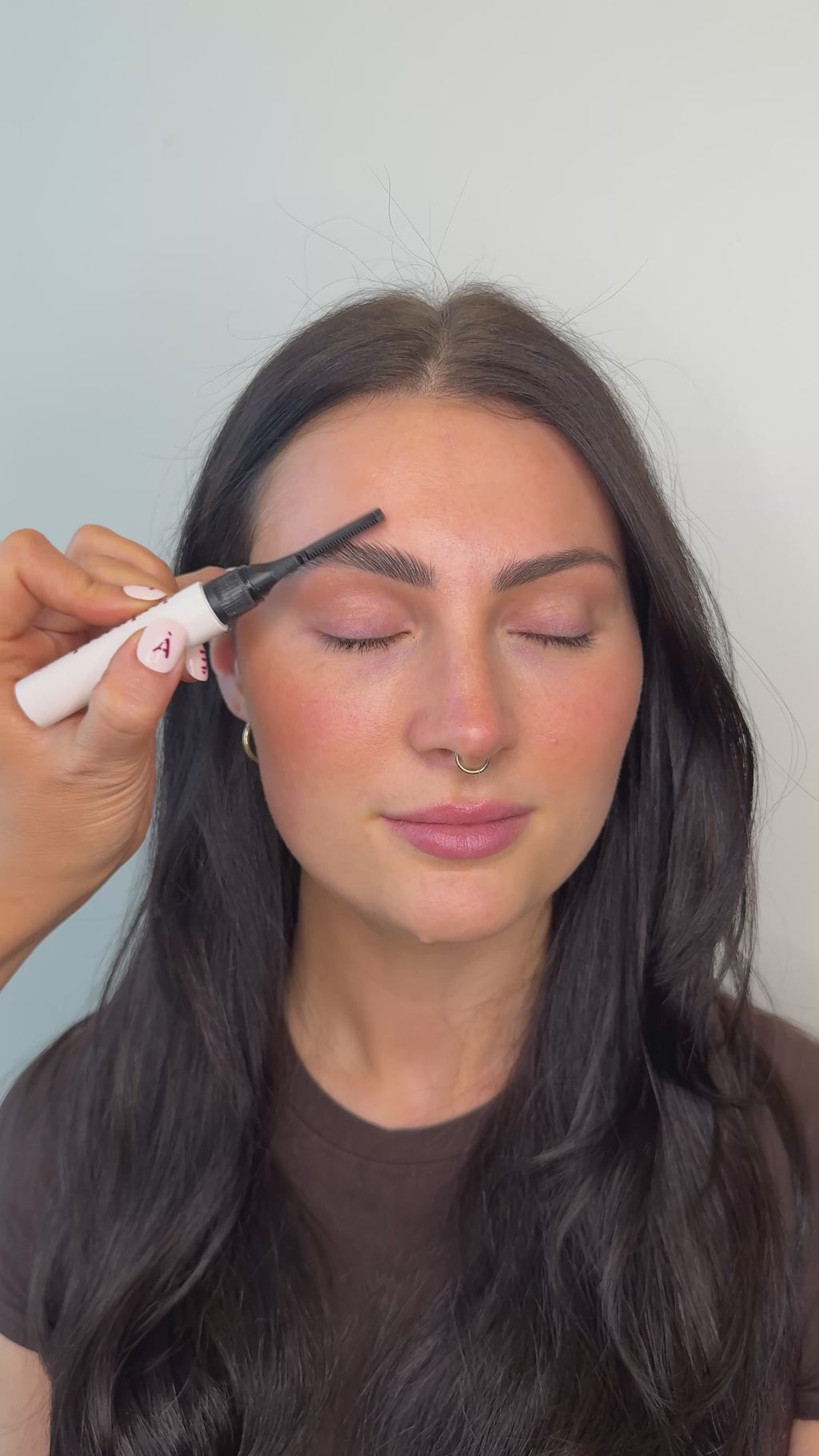 young woman applying product through manicured brows